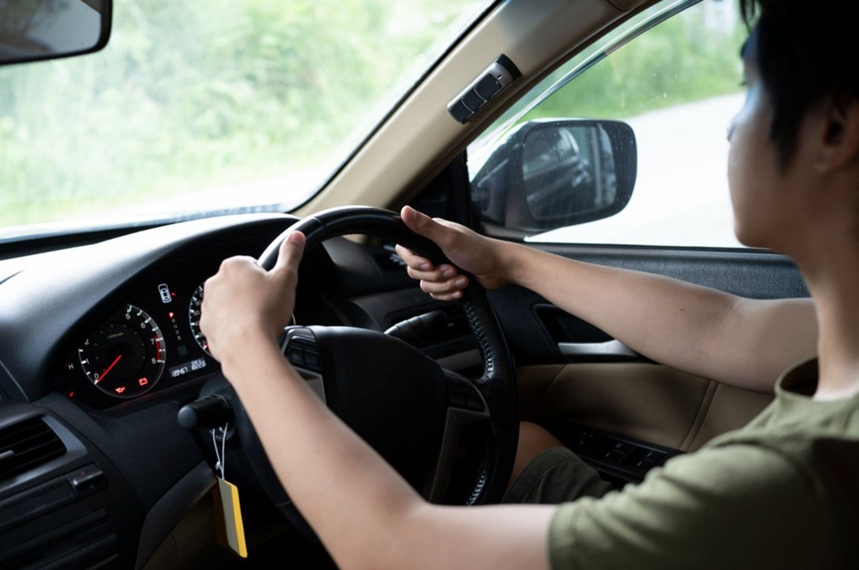 Hands on a car steering wheel during a test drive